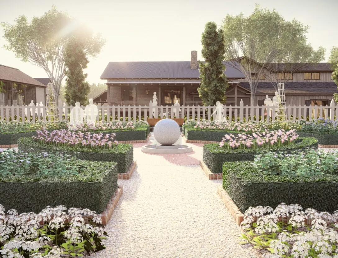 A formal garden with manicured hedges, flower beds, a central stone sphere fountain, and cottages in the background under the sunlight.