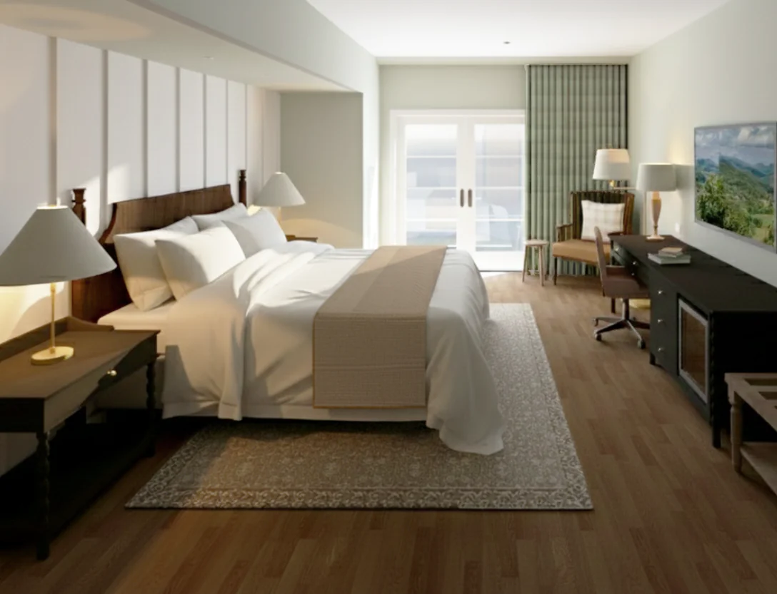 A modern hotel room with a large bed, bedside lamps, desk, chair, artwork on the walls, and natural light coming through glass doors.