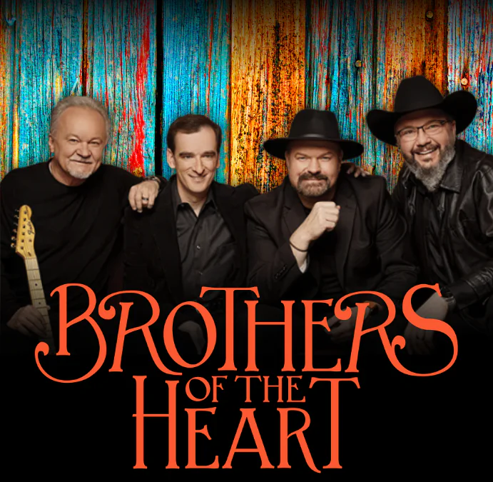 Four smiling men in black outfits and hats pose in front of a colorful wooden background with the words Brothers of the Heart in bold orange text.